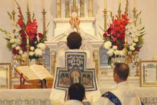 Altar with floral arrangements during Mass – Schedule